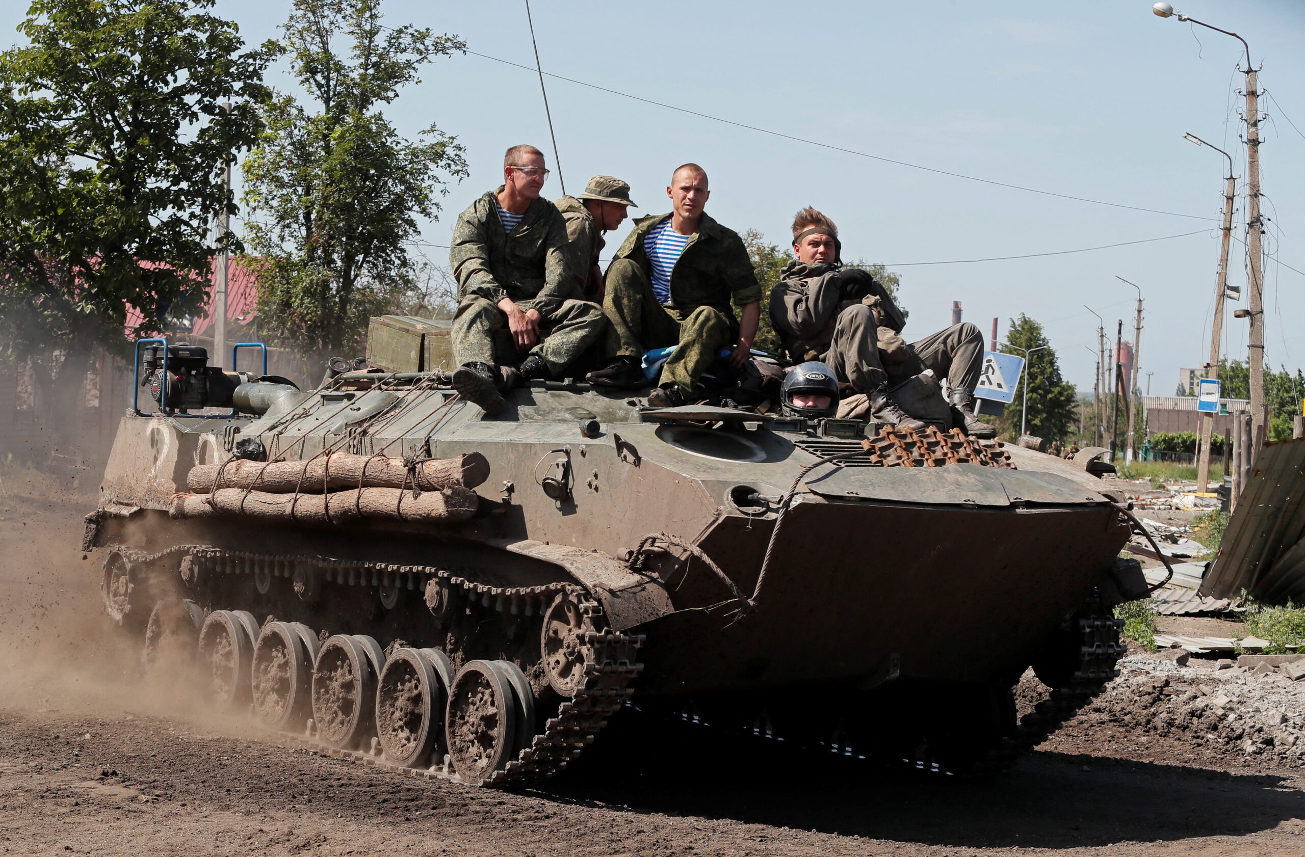 Service members of pro-Russian troops drive an armoured personnel carrier in Popasna